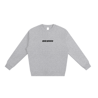 NEVER DEFEATED HEAVYWEIGHT SWEATSHIRT ‘GRAY’